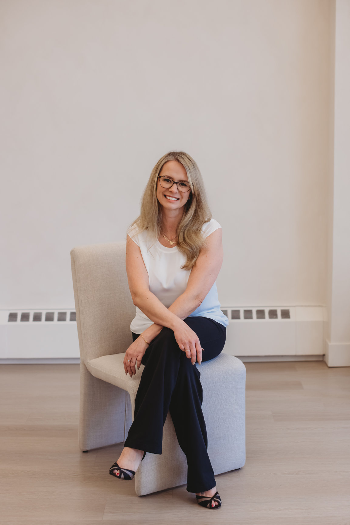 Sarah Hope seated in soft natural light, calm and attentive